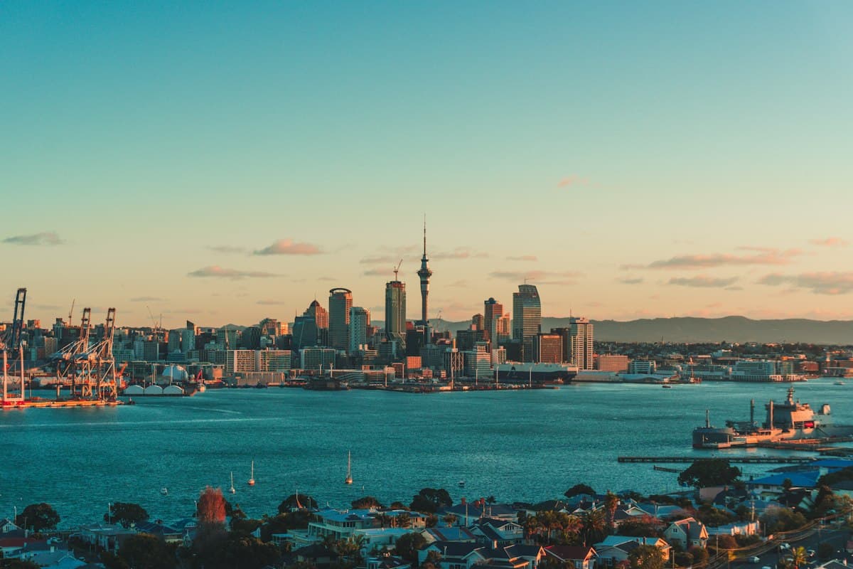 The Auckland skyline and Sky Tower over the harbour at sunset
