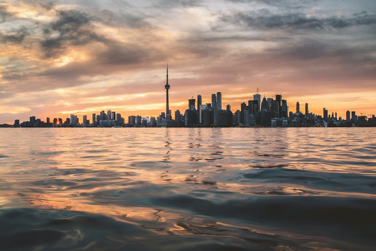 Toronto skyline and the CN Tower across Lake Ontario at golden hour