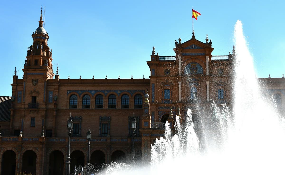 Plaza de España in Seville, with the Spanish flag above the fountain
